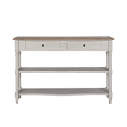 The Lyon Console Table, featuring a white farmhouse design with a natural wood top, two front drawers, and two lower open shelves, is shown against a plain white background.