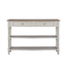 The Lyon Console Table, featuring a white farmhouse design with a natural wood top, two front drawers, and two lower open shelves, is shown against a plain white background.