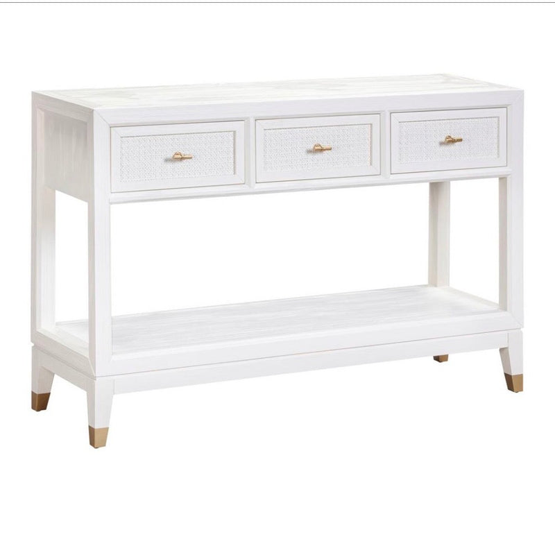The Bali 3 Drawer Console is a white wooden console table featuring three drawers with gold handles, an open lower shelf, and tapered legs with gold accents—effortlessly bringing coastal-inspired style to your living space.