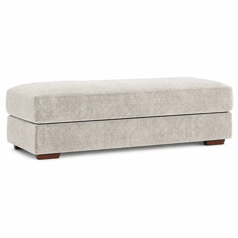 The Henley Footstool is a rectangular, light gray upholstered bench with short, dark wooden legs, displayed against a white background.