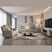 Sure! Here’s the revised sentence incorporating your product: Modern living room featuring two Lorenzo Electric Recliners in taupe washable fabric, complemented by a geometric rug, a coffee table with decorative accents, a floor lamp, striking wall art, and a TV on a sleek console. Large windows with sheer curtains bathe the space in natural light. The neutral and soft color palette completes the inviting atmosphere—perfect for relaxing or entertaining guests.