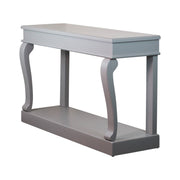 The Scroll Mink Console Table, shown against a white background, features a light gray sleek mink finish, elegantly curved legs, and a lower shelf.