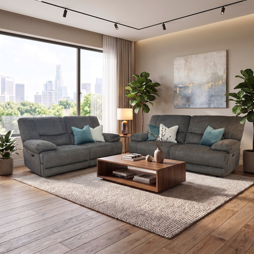 Two grey Gibson Electric Recliner sofas with blue and white throw pillows arranged around a wooden coffee table in a bright living room.