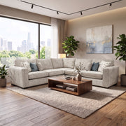Light gray Ivy Corner sectional sofa in a living room with a low wooden coffee table, area rug, and floor-to-ceiling windows overlooking a city skyline.