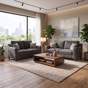 Two grey Irish-made Emperor Range sofas face each other over a wooden coffee table in a living room with a large window overlooking a city skyline.