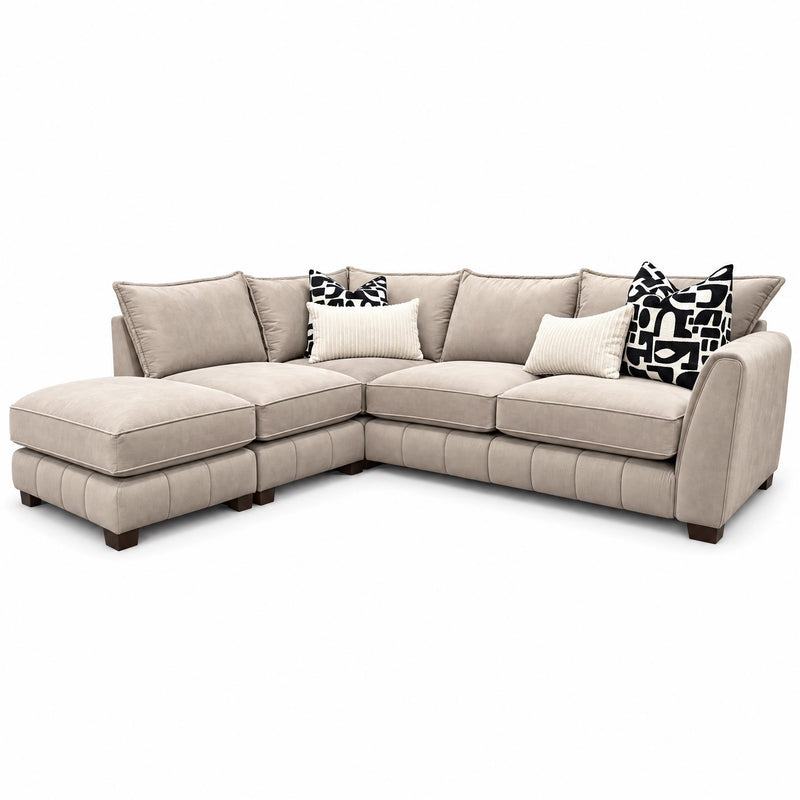 Beige Zoey Chaise Corner sofa with a left-side chaise, featuring solid cushions and throw pillows with black-and-white geometric patterns upholstered in Dura Clean fabrics.