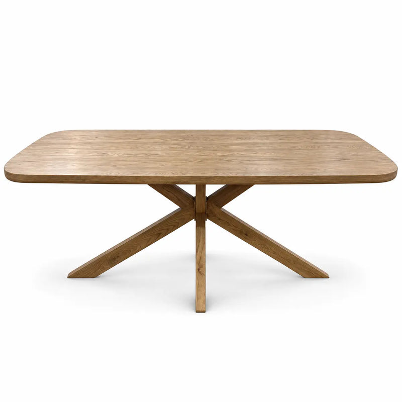 Ashton Dining Table in solid ash wood, featuring a rectangular top with rounded corners and an architectural four-legged crossed base.