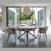 New York Dining table & 6 Macey Chairs with a black metal base, positioned in a room with floor-to-ceiling glass walls overlooking a patio.