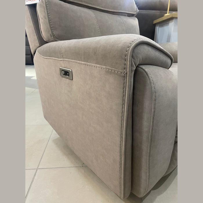 A close-up of the Sheldon Electric Recliner in light brown upholstery, featuring detailed stitching, a metal button panel with built-in USB port on the side, placed on a tiled floor.
