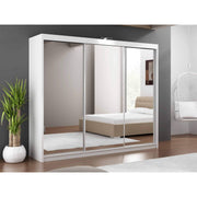 Modern white wardrobe with mirrored doors, situated in a bedroom setting with minimalistic decor.