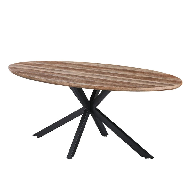 The Elson Oval Table features a smooth, light brown wooden top and a black metal base with four angled legs crossing at the center, all displayed against a plain white background.