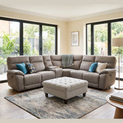 A light grey Jude Corner Sofa modular sectional with a matching tufted ottoman in a sunlit living room.