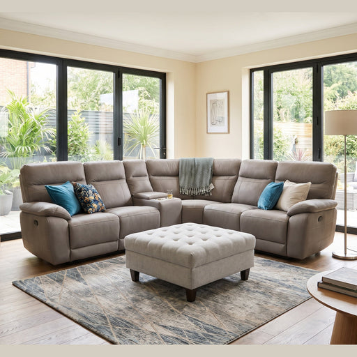 A light grey Jude Corner Sofa modular sectional with a matching tufted ottoman in a sunlit living room.