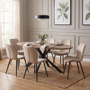 Elson Oval Table & 6 Lyra Chairs featuring an oval wooden table with a black metal base and six Lyra dining chairs with vertical tufting, arranged on a jute rug.