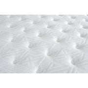 Close-up of the King Koil Boutique Sleep 1500 pocket spring mattress surface, showcasing its white quilted pattern, tufted buttons, geometric designs, and detailed stitching for a soft, cushioned, and plush finish.