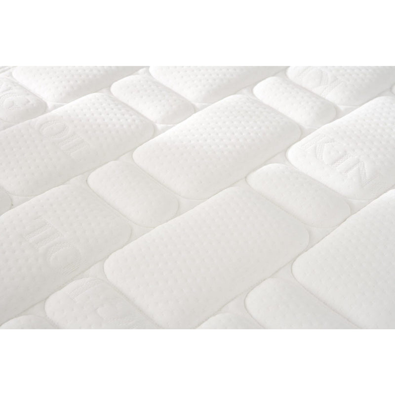 Close-up of the King Koil Spinal Guard (ICA) mattress by vendor-unknown, showing a white, textured quilted surface with rectangular and oval patterns. The cushioned fabric suggests comfort and optimal posture support.