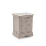 Traditional wooden bedside cabinet with carved plinth and decorative paneling.