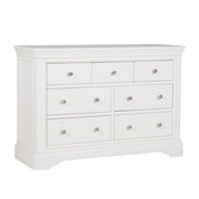 The Mabel Wide Chest by vendor-unknown features seven drawers, silver round knobs, a smooth top, and gently curved base edges—an ideal white wooden dresser to match your contemporary bed frame.