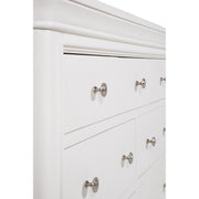 Close-up of the Mabel Wide Chest by vendor-unknown, a white dresser with multiple drawers and round silver knobs. Its smooth, polished finish and rounded edges suit contemporary spaces perfectly.