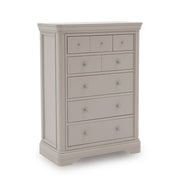 The Mabel Tall Chest by vendor-unknown is a tall, light gray wooden dresser with seven drawers, round silver knobs, and decorative molding—an ideal match for the contemporary Mabel Bedroom Collection.