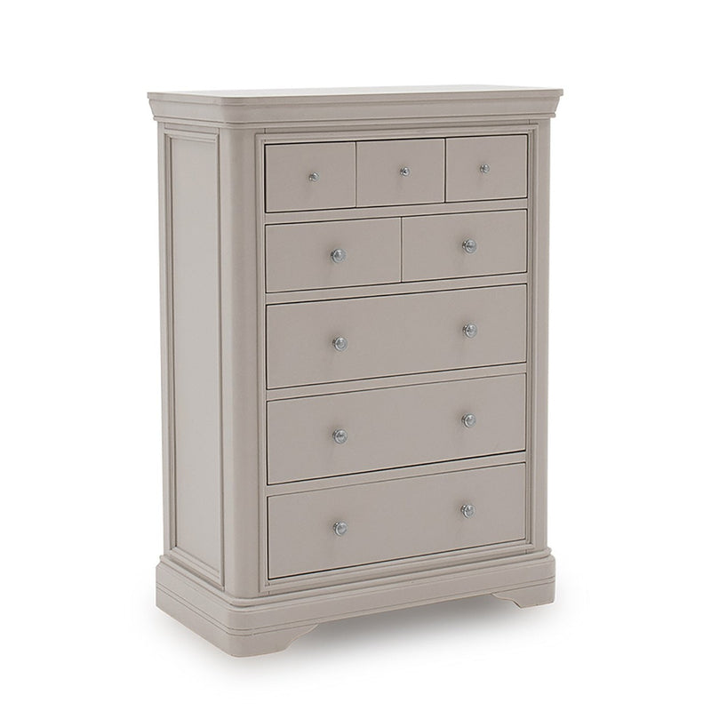 The Mabel Tall Chest by vendor-unknown is a tall, light gray wooden dresser with seven drawers, round silver knobs, and decorative molding—an ideal match for the contemporary Mabel Bedroom Collection.