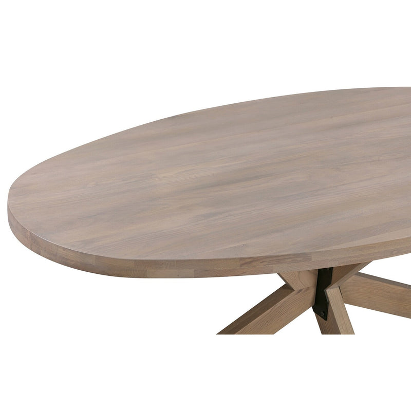A close-up of the Marlo Oval Table shows its smooth light American oak surface and a portion of its crossed wooden base.