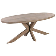 An oval dining table with a grey wash finish and a crisscrossed wooden leg base.