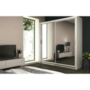 Space-saving white sliding closet with mirrored door, reflecting the interior of a minimalist room.