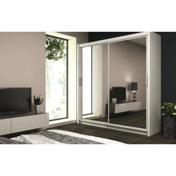 Space-saving white sliding closet with mirrored door, reflecting the interior of a minimalist room.