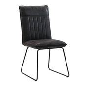 A black dining chair with a hard backrest and seat, featuring a metal base and upholstered in PU leather.