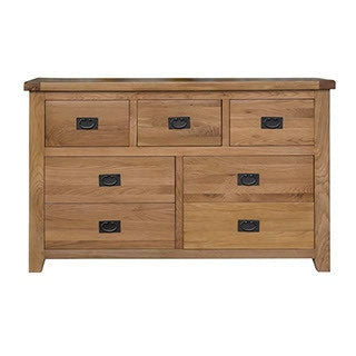 A solid oak chest of drawers with a shiner lacquered finish, featuring multiple drawers with metal handles.
