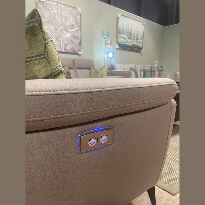 A close-up of the Chloe 3+2 Electric Recliner Sofa’s beige arm with illuminated control buttons. The cozy living room features abstract wall art, green pillows, and modern decor in the background.
