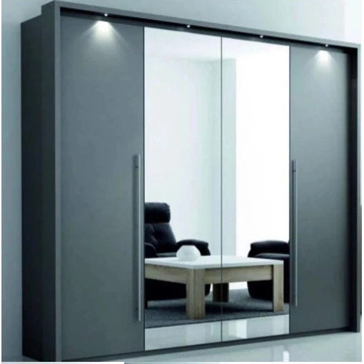 The Brema Sliderobe by vendor-unknown is a modern mirrored sliding door wardrobe with large doors that reflect a black armchair and wooden table in a bright, minimal room. Three spotlights above add elegance.