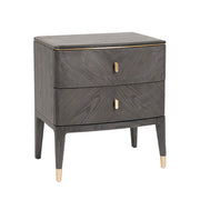 The Diletta Bedside Locker features modern ebony wood, two drawers with gold handles, gold-capped legs, a smooth finish, and rounded corners—making it a stylish addition to your bedroom furniture collection.