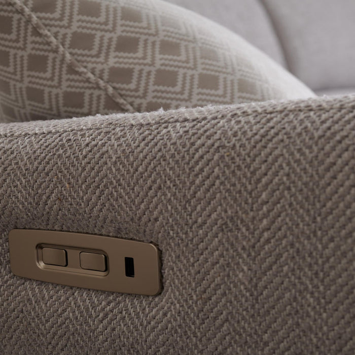 Close-up of an Otis Range light gray upholstered recliner arm with a geometric cushion and an embedded electronic control panel featuring two buttons to adjust the electric headrest.