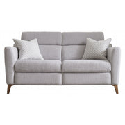 The Otis Sofa Range features a light gray modern design with two seat and back cushions, angled wooden legs, and two patterned throw pillows. Upholstered in durable aquaclean fabric for easy maintenance.