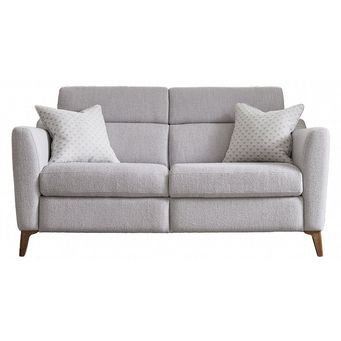 The Otis Range is a modern light gray fabric sofa with supportive lumbar, wooden legs, two matching patterned throw pillows, and a clean-lined design.