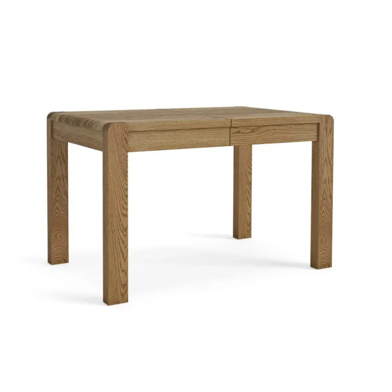 A rectangular oak dining table with visible wood grain, in a natural wood finish.