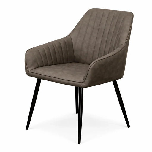 The Enzo Dining Chair features a brown upholstered seat and back with vertical stitching, black metal angled legs, and curved armrests—making it a stylish suede dining chair for your space.