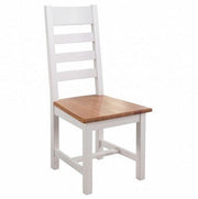 The Skellig Dining Table & 6 Chairs set features wooden chairs with white frames, slatted backrests, and oak top seats, shown against a plain white background.