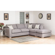 A large gray corner sofa with a right-hand configuration, featuring a deep foam seat, high backs, and placed in a room with a neutral color scheme.