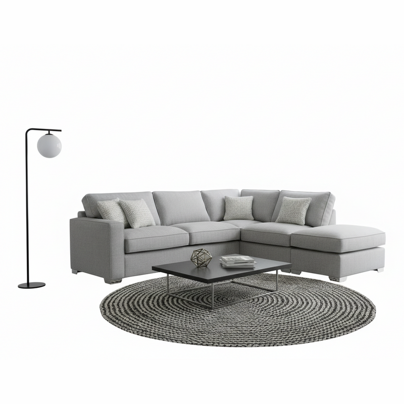 The Chicago Corner Group, shown on a white background, features a light gray corner sofa with four cushions, a black floor lamp with a round white shade, a low rectangular coffee table, and a round woven rug for modern living rooms.