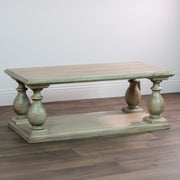 The Marwood Coffee Table is a rectangular wooden piece with a light finish, four thick baluster-style legs, and a lower shelf. Dimensions: 120 cm wide, 45 cm high. It sits on a hardwood floor against a plain white wall.