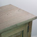 A close-up of the Marwood Large Sideboard Console's top corner shows its light wood grain and slightly weathered finish against a plain background. Dimensions: 82 cm high, 150 cm wide.