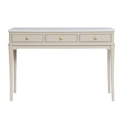 The Monroe Large Console - Stone features a light beige finish, three drawers with round knobs, a marble top, and four tapered legs—an elegant storage piece for your living space.