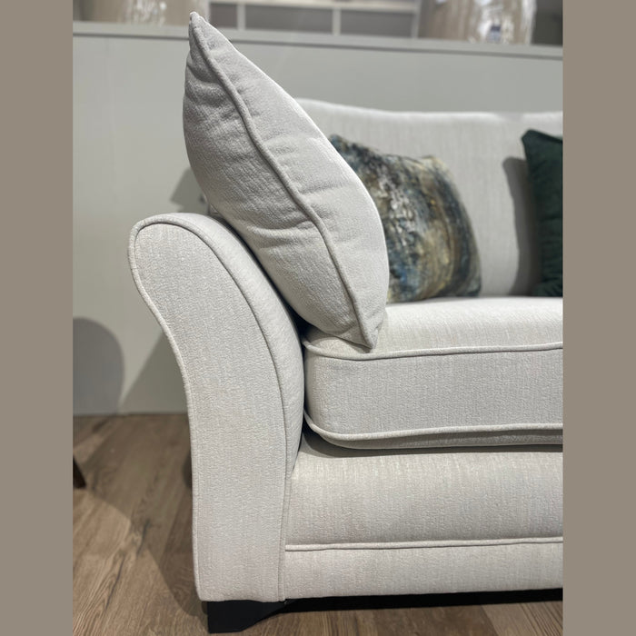 Close-up of the Savoy sofa by vendor-unknown, Irish-made with light gray Aquaclean fabric. Plush armrest and cushion, two decorative pillows (one patterned, one dark green), and a made-to-measure design on a wooden floor.