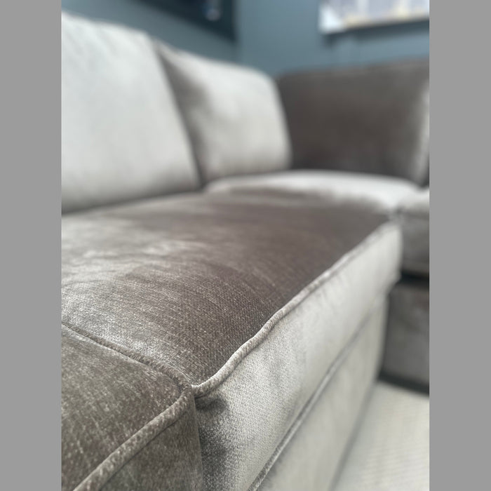 Close-up of the Ariya Corner Sofa, showcasing its plush textured light gray and brown upholstery, with comfortable seat cushions and backrest—ideal for elevating your living room.