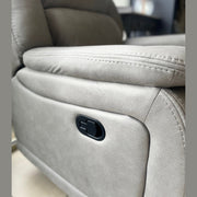 Close-up of the light gray Reno Recliner Sofa, highlighting the side panel with a black reclining lever. The detailed stitching and texture of the washable fabric are clearly visible.
