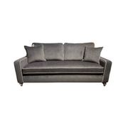 The Emperor Range sofa is a modern dark gray velvet suite with white piping, angled armrests, two matching throw pillows, and crafted from Aqua Clean fabrics, shown against a white background.