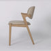 The Mila Beige PU Dining Chair is a modern chair with a solid wood frame and light beige PU cushioned seat and backrest, shown in profile against a white background. It features clean, angular lines and minimalist design.
